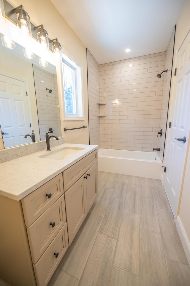 bathroom featuring vanity and tiled shower / bath combo