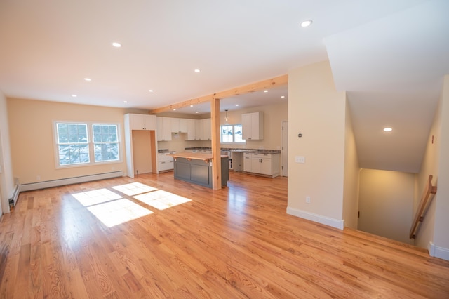 unfurnished living room featuring light hardwood / wood-style floors and a baseboard radiator