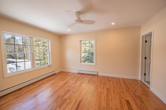 unfurnished room featuring light wood-type flooring, a baseboard radiator, and ceiling fan