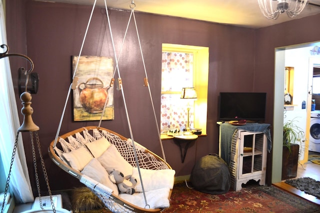 interior space with washer / clothes dryer, tile patterned floors, and a notable chandelier