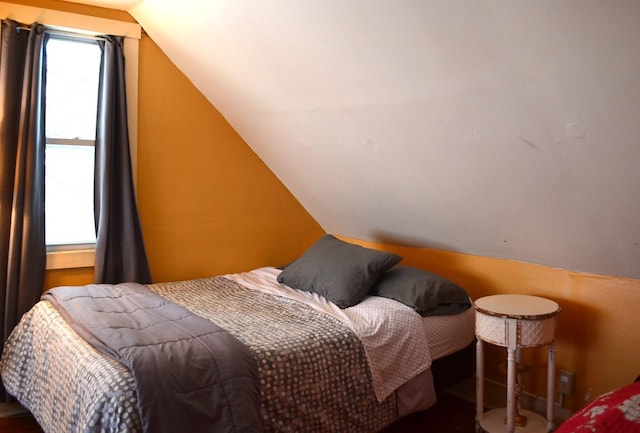 bedroom with lofted ceiling