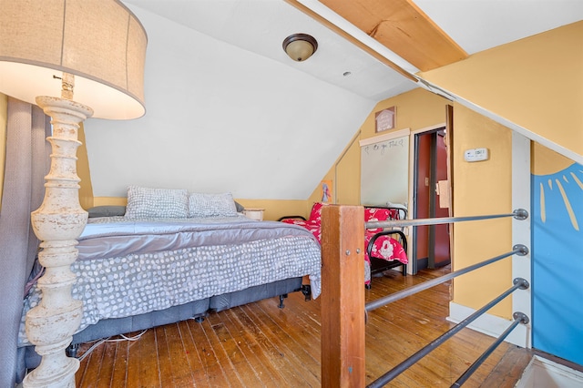 bedroom featuring wood-type flooring and lofted ceiling