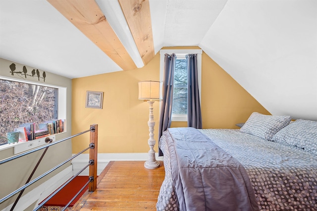 bedroom with hardwood / wood-style floors and vaulted ceiling