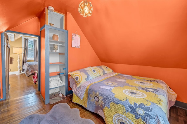 bedroom featuring hardwood / wood-style floors and lofted ceiling