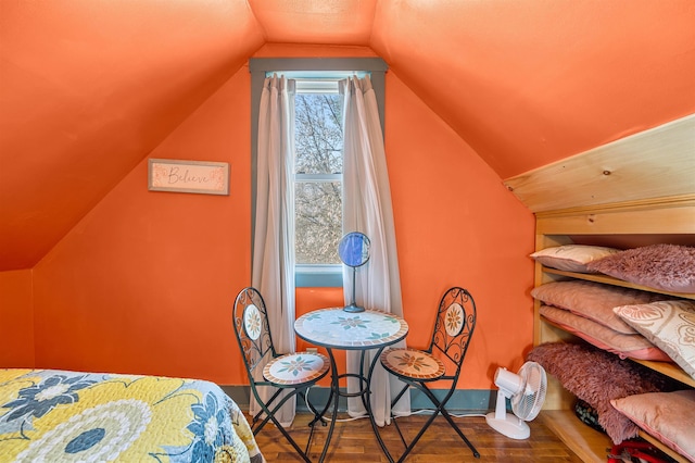 bedroom featuring hardwood / wood-style floors and lofted ceiling