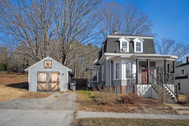 view of front of home with a storage shed