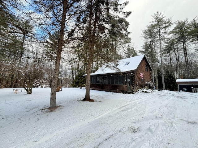 snowy yard with a sunroom