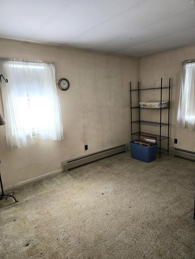 unfurnished room featuring carpet flooring and a baseboard radiator