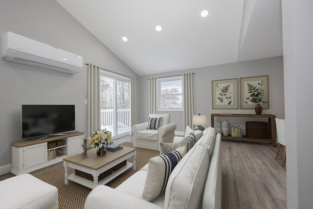 living room with hardwood / wood-style floors, lofted ceiling, and an AC wall unit