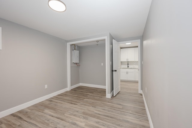 unfurnished bedroom with a closet and light hardwood / wood-style flooring