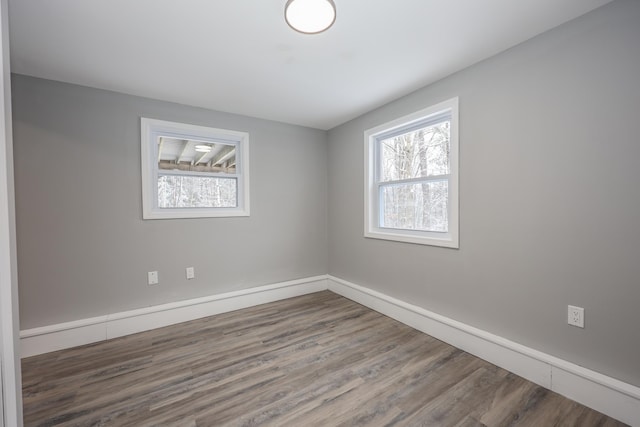 empty room with hardwood / wood-style flooring