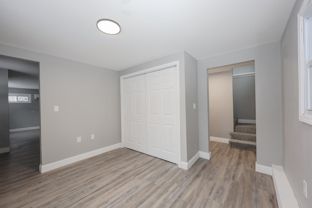 unfurnished bedroom with hardwood / wood-style floors and a closet