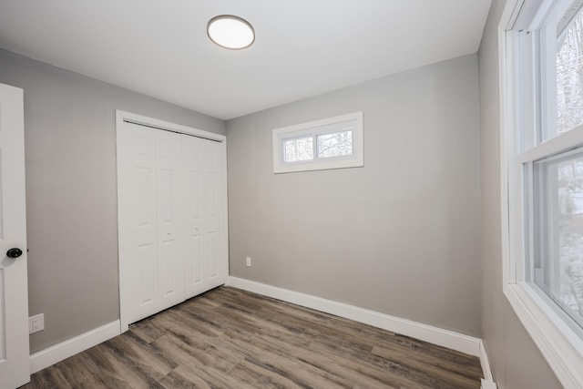 unfurnished bedroom with hardwood / wood-style flooring and a closet