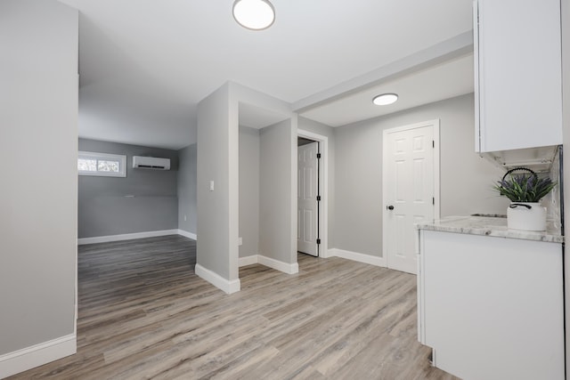 interior space featuring light hardwood / wood-style flooring and a wall unit AC