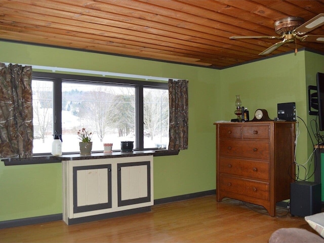 interior space with a wealth of natural light, light hardwood / wood-style flooring, ceiling fan, and wooden ceiling