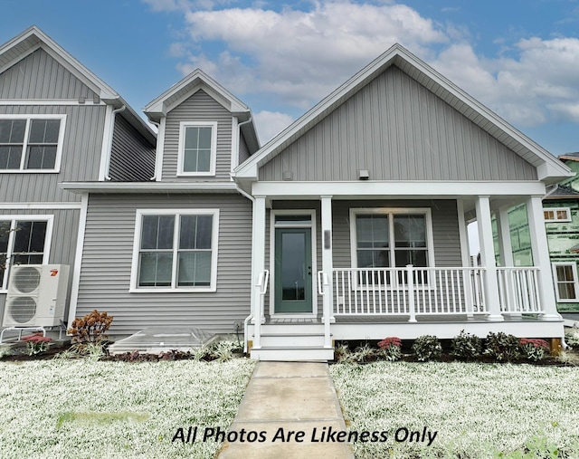 view of front of home featuring ac unit and a porch