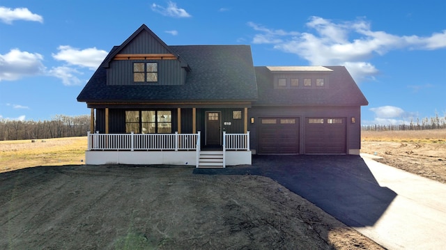 17 Durant Rd, Berwick, ME 03901 - view of front of home featuring a porch, asphalt driveway, an attached garage, roof with shingles, and board and batten siding
