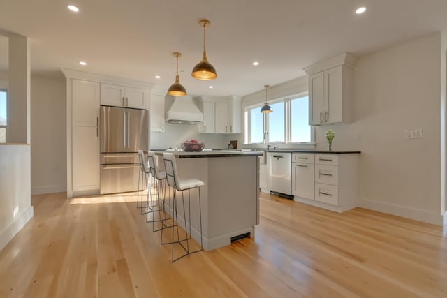 17 Durant Rd, Berwick, ME 03901 - kitchen with stainless steel appliances, custom exhaust hood, dark countertops, light wood-type flooring, and recessed lighting