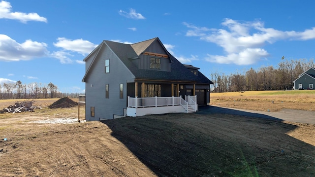 17 Durant Rd, Berwick, ME 03901 - view of front of home featuring covered porch, dirt driveway, and a garage