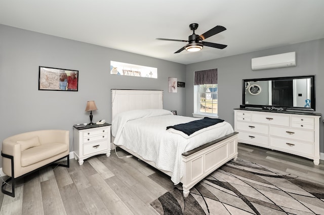 19 Whippoorwill Way, Somersworth, NH 03878 - bedroom featuring a wall mounted air conditioner, light wood-type flooring, and a ceiling fan