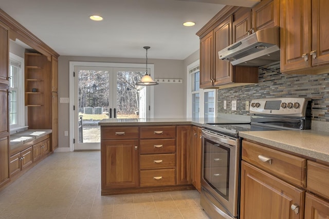 kitchen with backsplash, pendant lighting, stainless steel range with electric cooktop, and french doors