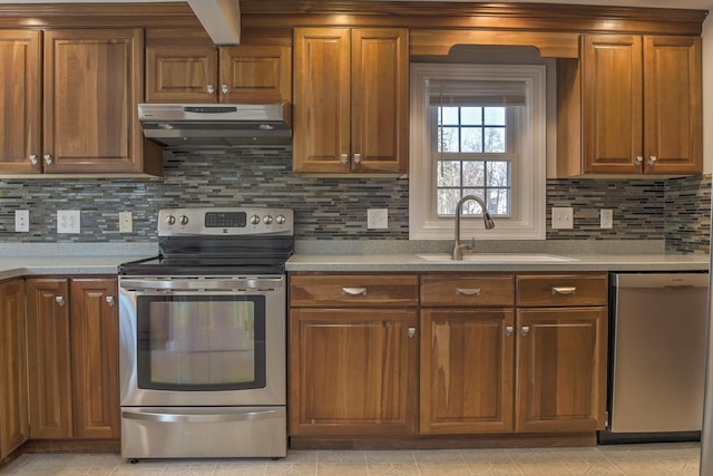 kitchen with tasteful backsplash, sink, and stainless steel appliances