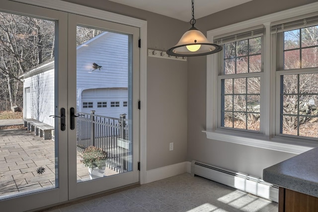 entryway featuring french doors, a healthy amount of sunlight, and a baseboard radiator