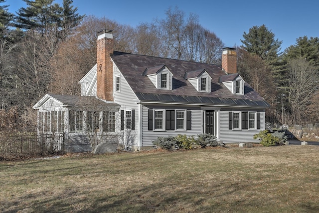 view of front facade with a front yard and a sunroom