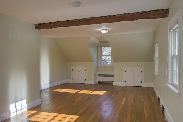 bonus room featuring radiator heating unit, dark hardwood / wood-style flooring, and vaulted ceiling with beams