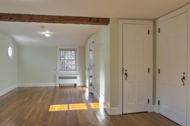 entrance foyer with beam ceiling, hardwood / wood-style flooring, and radiator