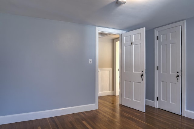 unfurnished bedroom featuring dark hardwood / wood-style floors