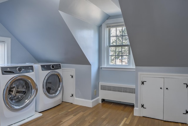 laundry room featuring radiator, light hardwood / wood-style floors, and independent washer and dryer