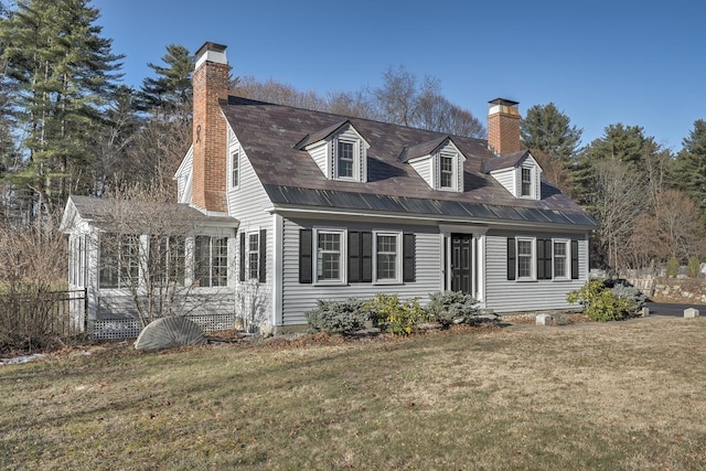 cape cod house with a front lawn