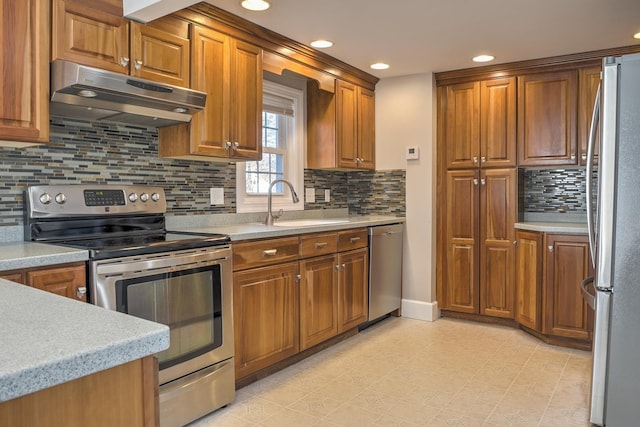 kitchen featuring sink, appliances with stainless steel finishes, and tasteful backsplash