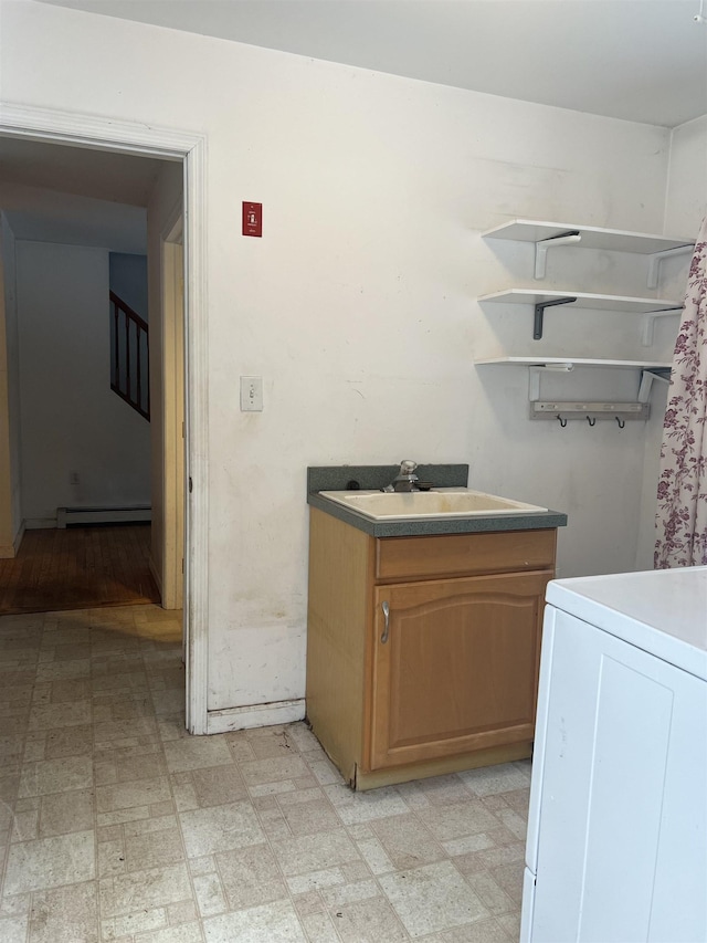 washroom featuring washer / dryer, sink, and a baseboard radiator