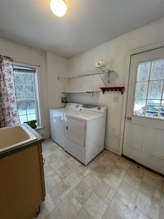 laundry area featuring cabinets, independent washer and dryer, plenty of natural light, and sink