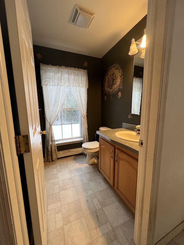 bathroom featuring vanity and toilet