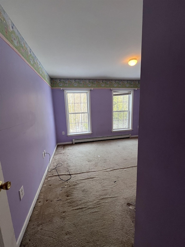 empty room with carpet flooring and a baseboard radiator