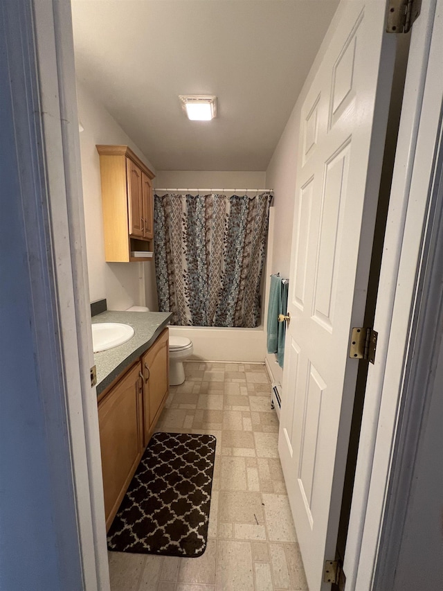 full bathroom with vanity, a baseboard heating unit, toilet, and shower / tub combo with curtain