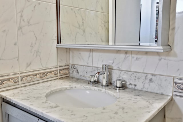 interior space featuring vanity and tasteful backsplash