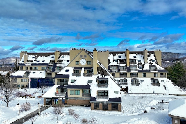 snow covered property featuring a mountain view