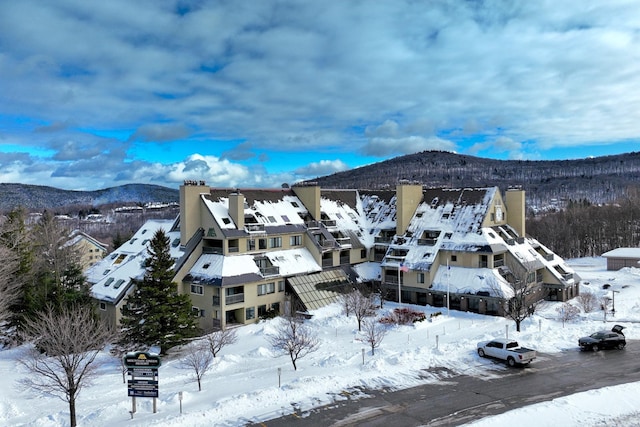 snowy aerial view with a mountain view