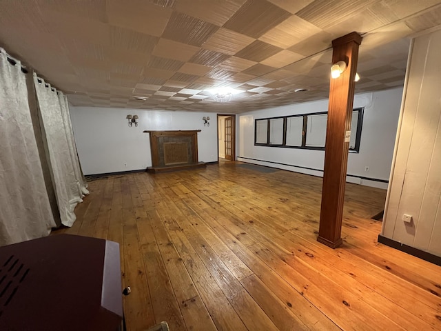 basement with hardwood / wood-style flooring