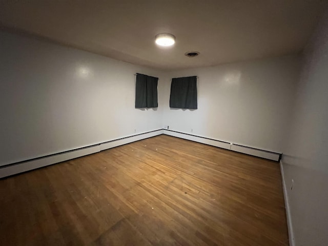 spare room featuring wood-type flooring