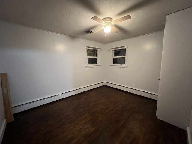 spare room featuring ceiling fan, a textured ceiling, and dark hardwood / wood-style flooring