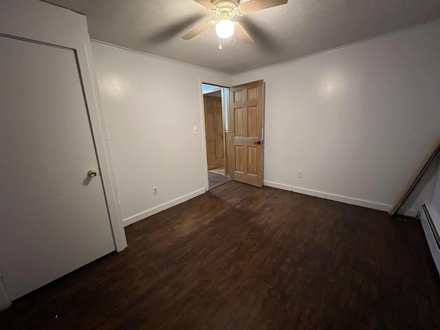 unfurnished bedroom featuring ceiling fan and dark hardwood / wood-style flooring