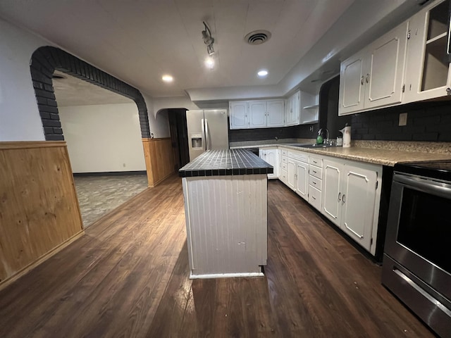 kitchen with white cabinetry, stainless steel appliances, a center island, and sink