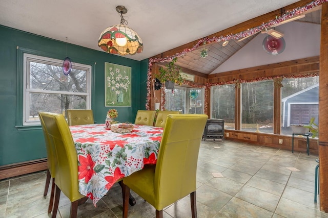 tiled dining room with lofted ceiling