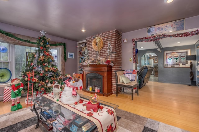 living room featuring a large fireplace and hardwood / wood-style floors