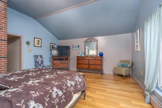 bedroom with lofted ceiling and light hardwood / wood-style floors